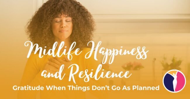 A woman stands in the kitchen with both of her hands over her heart as she practices gratitude to build midlife happiness and resilience.